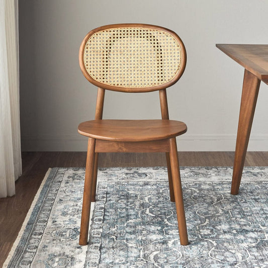Handcrafted premium rattan dining chair with solid wood frame and cane back, modern mid-century style for elegant dining spaces.